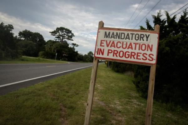 A mandatory evacuation sign is seen ahead of the arrival of Hurricane Idalia, in Cedar Key, Florida, U.S., August 29, 2023. REUTERS/Marco Bello